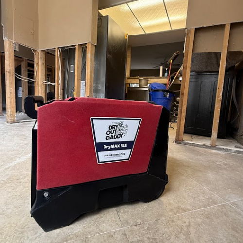 Dry Out Daddy branded dehumidifier on a water damage job